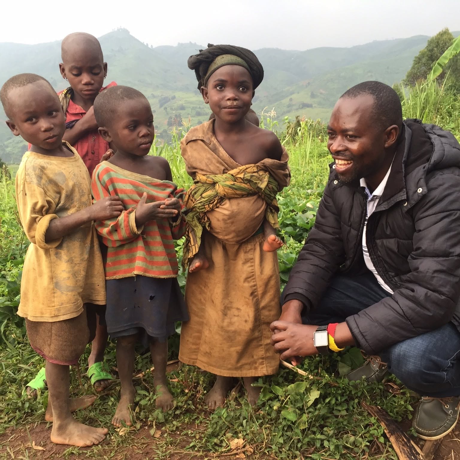 NCE volunteers reading scripture with a community in Masisi