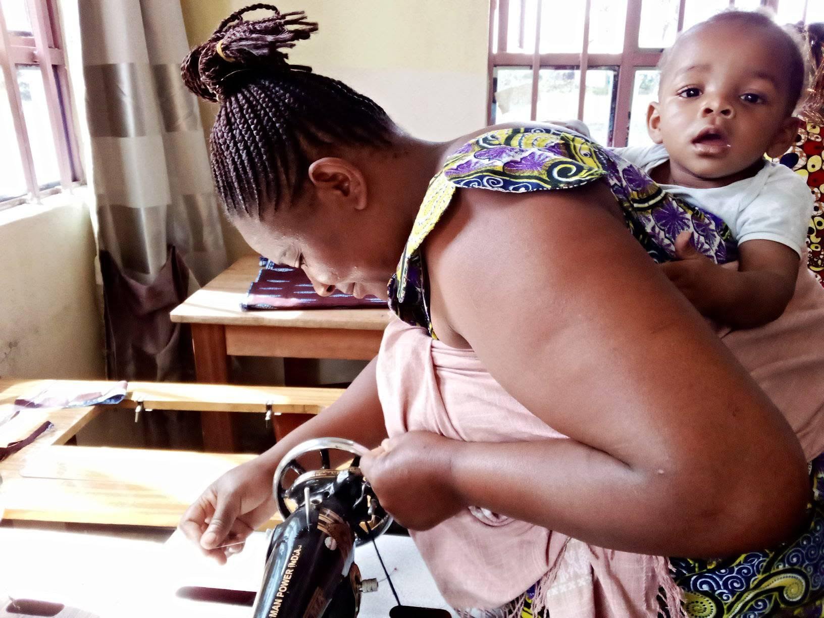 Esther Project graduate with her sewing machine