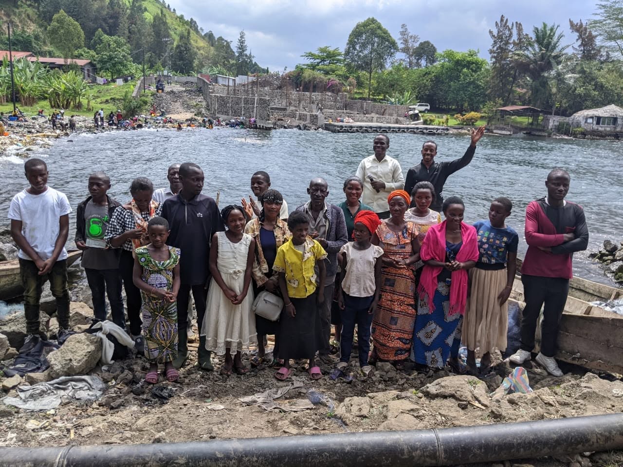 NCE outreach ministers praying with a family at a displacement camp