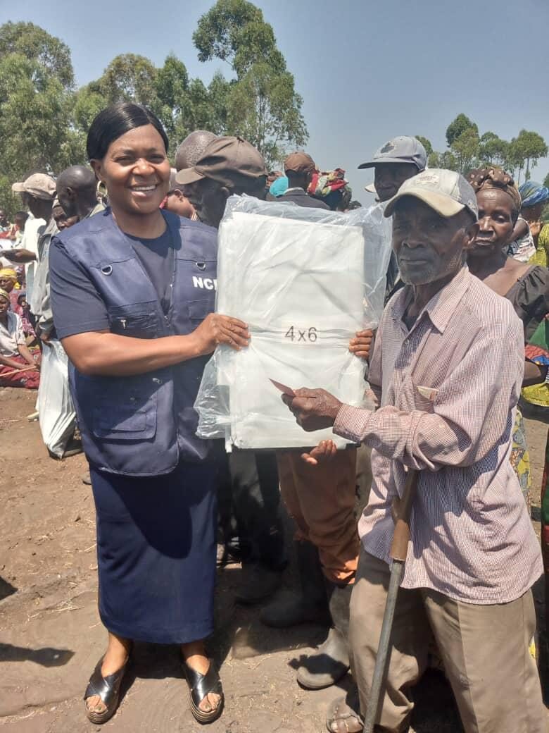 NCE distributing relief supplies to a community in need