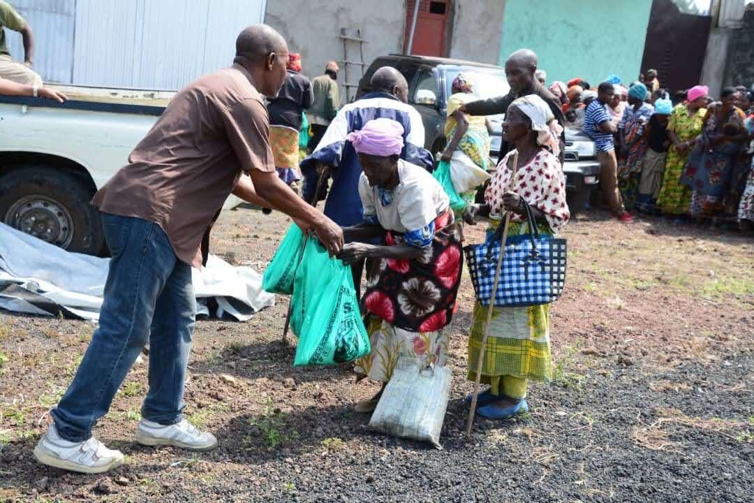 Young man carrying a sack of grain for relief distribution