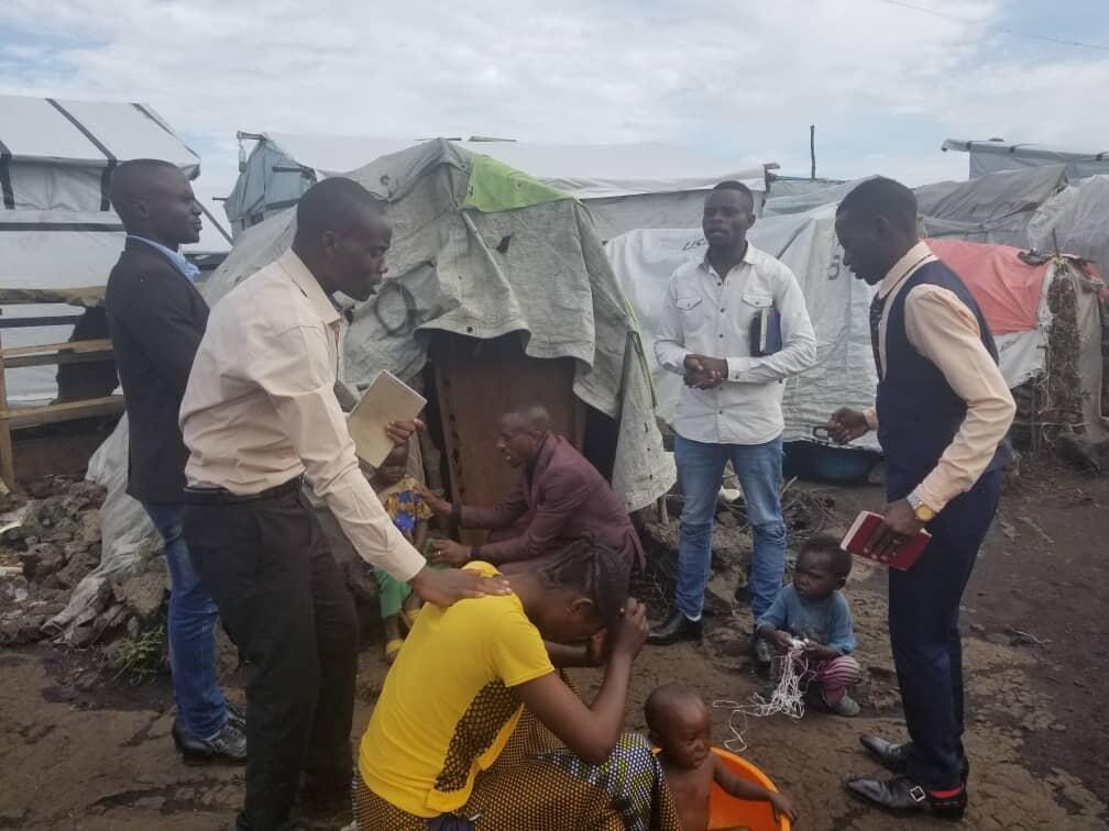 Community member carrying a water tank